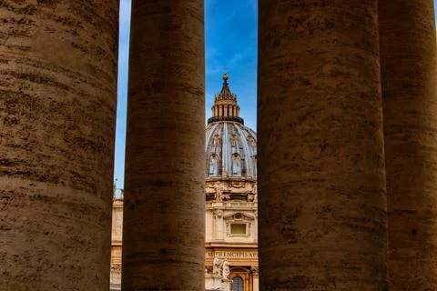 View through a few columns on St. Peter's Basilica. Stock Photos