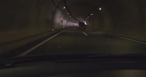 View through front window of car of the exit of long Japanese expressway tunnel 库存影片 108744096