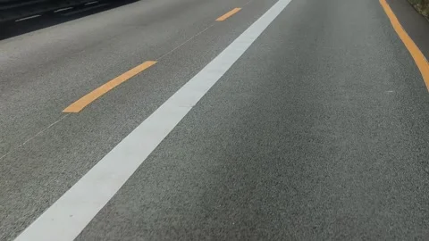 View through the front windshield window onto asphalt road with traffic Video stock 305506488