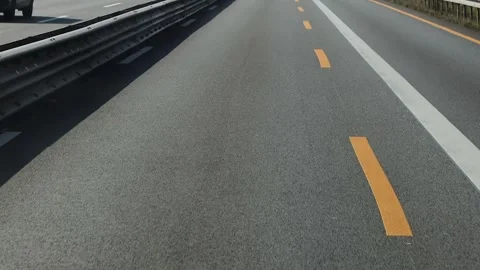 View through the front windshield window onto asphalt road with traffic Video stock 305506489