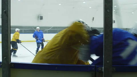 View through Glass Barrier of Men Playing Hockey Stock Footage 147647864