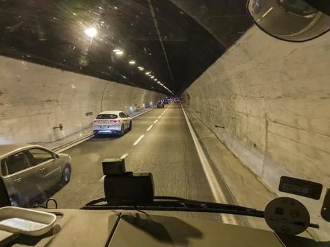 View through the glass of a car on the road in a tunnel with cars Stock Photos