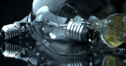 View through the glass. LIght bulb among other light bulbs on black background Stock Footage 143647137