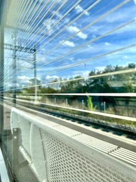 A view through a glass window on a train platform Stock Photos