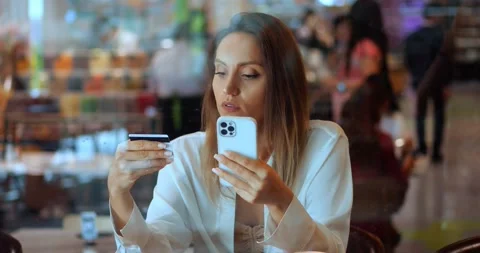 View through the glass windows of a cafe to young woman shopper, customer Stock Footage 220772873