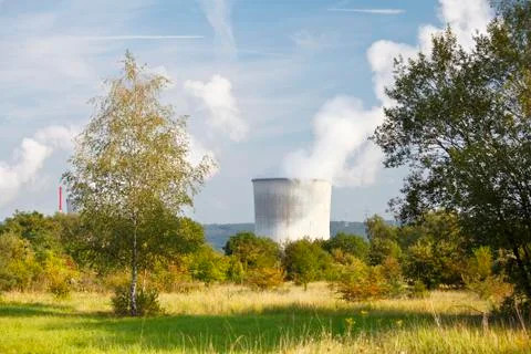 View through green landscape to the cooling towers of a nuclear power station Stock Photos