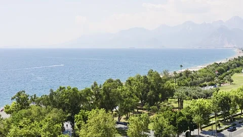 View through green pine trees toward the blue Mediterranean Sea from an ele.. Vidéo 339640257