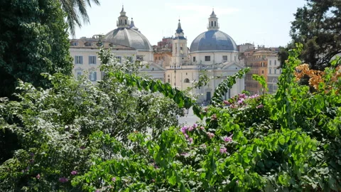 View through green trees on churches on Piazza del Popolo in Rome, Italy - 4K Stock Footage 156459622