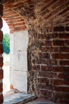 View through a historic arched window in a medieval brick fortress wall Stock Photos