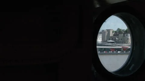 The view through HMS Belfast port hole of the tower of London as a ferry passes Stock Footage 44124558