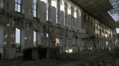View through large windows of ruined old buildings on factory yard, pan left. Stock Footage 57371547