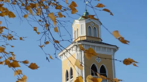 View through leaves bell tower of wooden lutheran church in Kerimaki, Finland Stock Footage 119273333