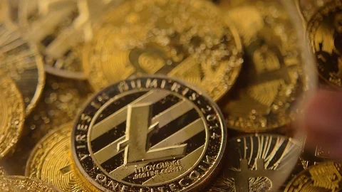 View Through Loupe on Litecoin Obverse on Coins Pile Macro Vídeos de archivo 83720958