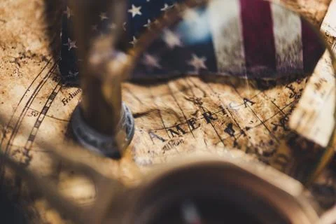 View through magnifier on old map, showing "America" word. Stock Photos