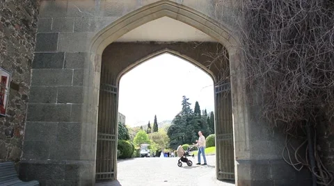 View through a medieval stone arch at the park. Vídeo Stock 49492877