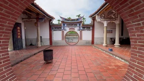 View through moon door of ancestral house country yard Stock Footage 266234257