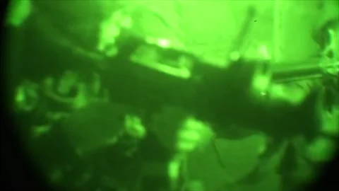 View through night vision in a mission operation.Subdivision army anti terrorist Stock Footage 139477366