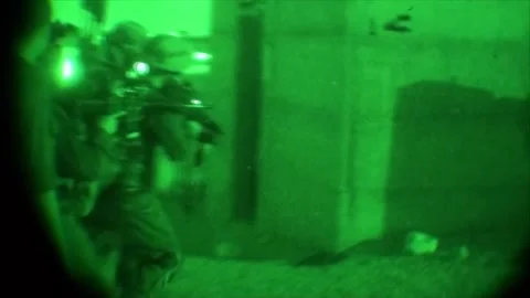 View through night vision in a mission operation.Subdivision army anti terrorist Stock Footage 139477377