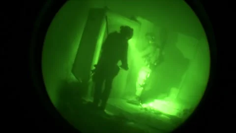 View through night vision in a mission operation.Subdivision army anti terrorist Stock Footage 139477422