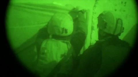 View through night vision in a mission operation.Subdivision army anti terrorist Stock Footage 139477427