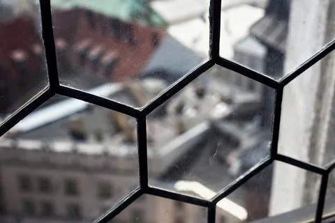 View through an old dusty window on historic buildings. Stock Photos