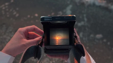 View through old film camera viewfinder. Female hands holding retro analogue tlr Stock Footage 254486054