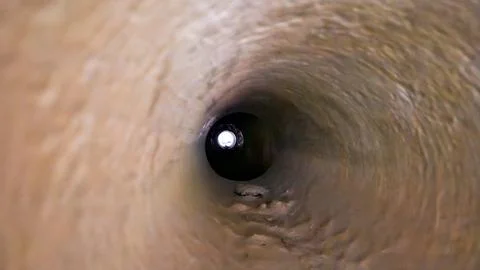 View through an old metal pipe tunnel Stock Photos