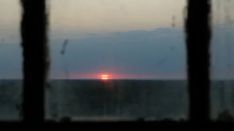 View through old window on sunset, point of view through the window Stock-Footage 95985023