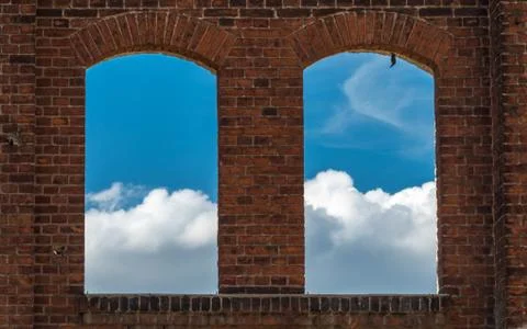 The view through the old window without glass on the clouds Stock Photos