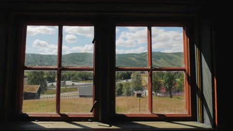 View through the old window of a wooden house to the picturesque nature of Stock Footage 151888456