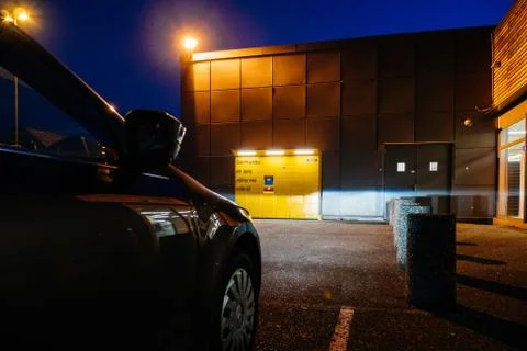 View through parked car to Amazon Locker delivery tecnology point of parcels Stock Photos