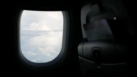 View through the plane window with thick cloud above the beautiful sky, clo.. Video stock 248028798