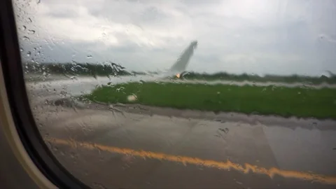 View through porthole, focus on the wet glass, during take-off Stock Footage 89363002