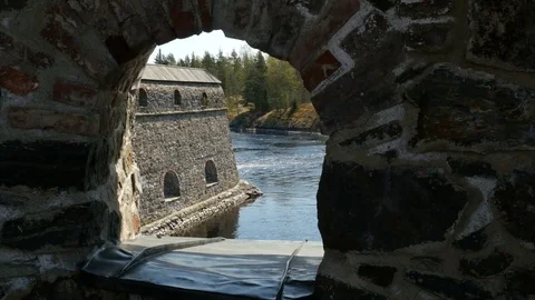 View through the porthole of a medieval castle on the river Stockbeeldmateriaal 80610096