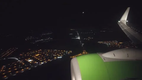 View through the porthole of the plane wing and night city Stock Footage 155901285