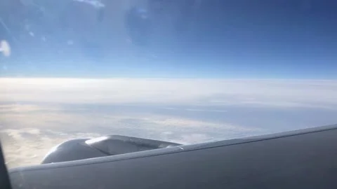 View through the porthole on the wing and clouds. Airplane wing through the Video stock 203815445