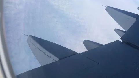 View through the porthole on the wing and clouds. Airplane wing through the Stock-Footage 207413593