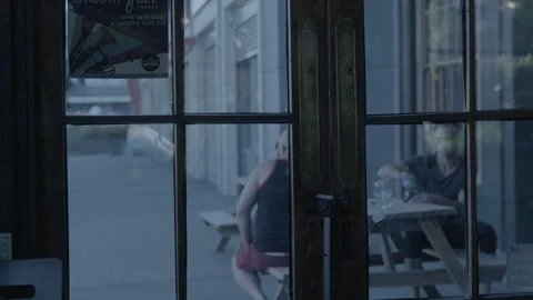 View Through Pub Glass Door to Outdoor Street Seating Stock Footage 343097351
