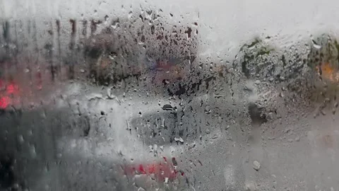 View through a rain covered windshield from a moving car approaching a ferr.. Stock Footage 340283199