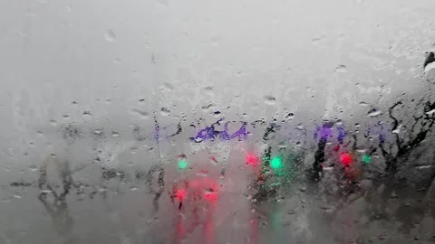 View through a rain covered windshield from a moving car approaching a ferr.. Stock Footage 340283200