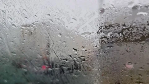View through a rain covered windshield from a moving car approaching a ferr.. Stock Footage 340916986