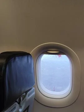 A view through a raindrop glass from a window seat in the airplane on the rai Stock Photos