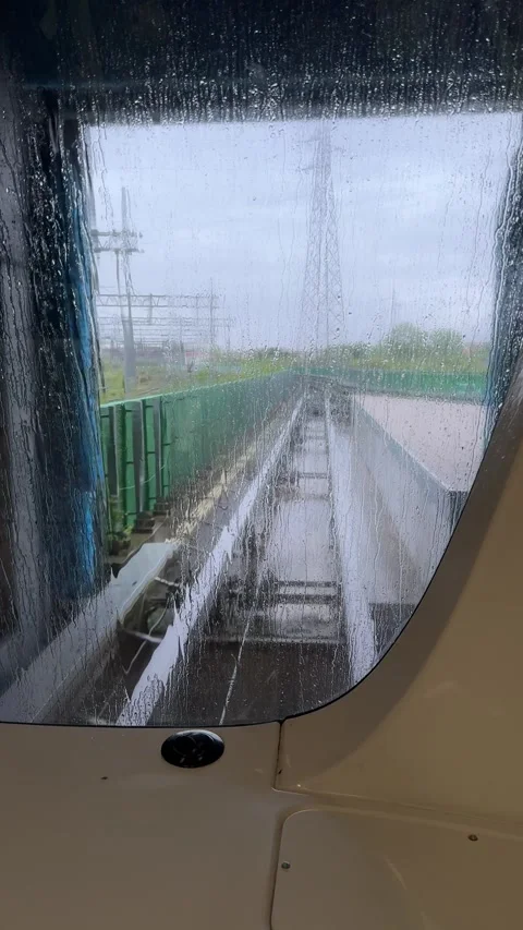 View through rainy front window of train approaching city from Pisa airport Stock Footage 306959826