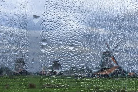 View Through a Rainy Window to Old Windmills in the Netherlands Stock Photos
