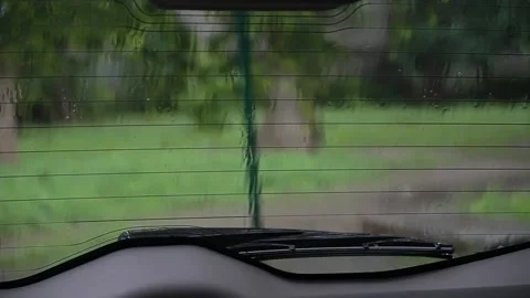 View through the rear window of the car in the rain. drops drain from tglass Stock Footage 195213467