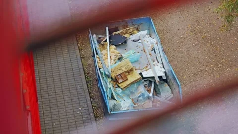 View Through Red Metal Ladder Gaps Onto Blue Container Filled Video stock 324945011