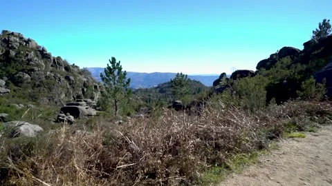 View through rocky valley with mountains in Portugal on sunny day Stock Footage 264099396