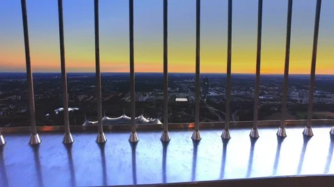 View through the safety bars on Olympia Tower of Munich and Olympic Stadium Stock Footage 107498279