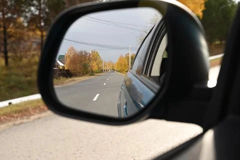 View through the side mirror of the autumn forest Stock Photos