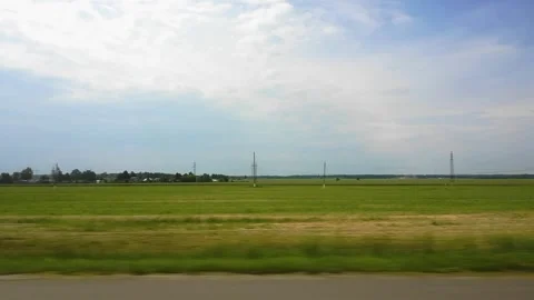 View through the side window of car auto in motion on road along the field and Stock Footage 140780159